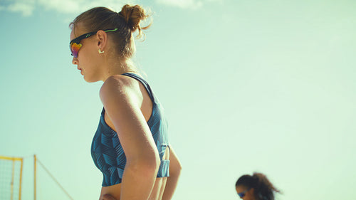 Medium shot of professional female volleyball players hyping each other up before an important match