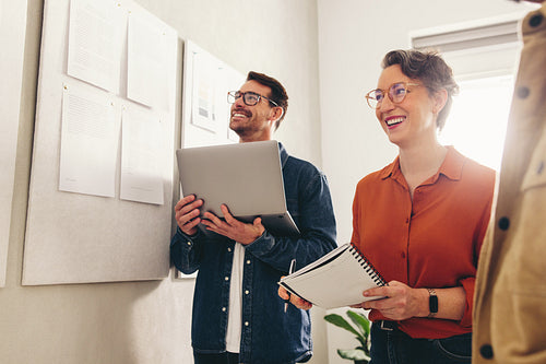 Cheerful businesspeople having a meeting in a creative workplace