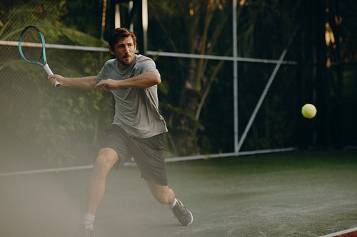 Tennis player executing a forehand shot