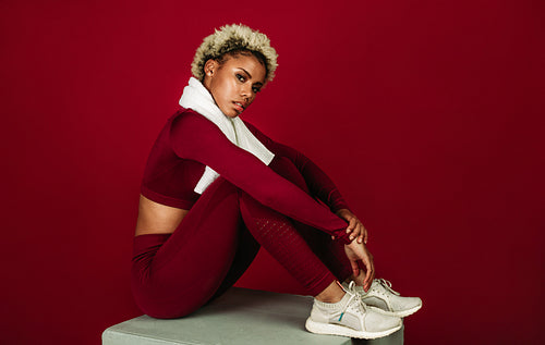 African american fitness woman sitting on exercise block