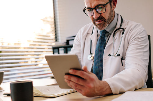 Doctor making use of technology in his diagnosis
