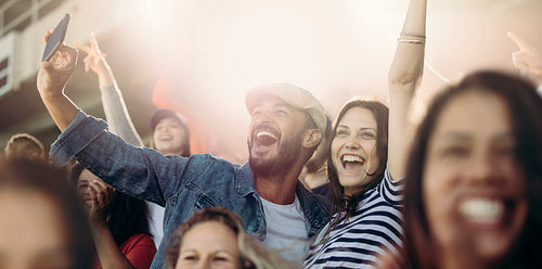 Soccer fans taking selfie at  match