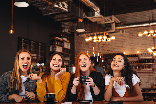 Female friends enjoying a weekend at a coffee house