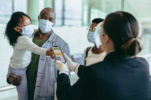Family at check-in counter showing vaccine passport