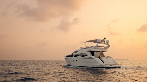 Luxury motorboat cruising at sunset during a vacation on the open sea