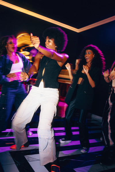 Group of friends enjoying a lively night out dancing at a vibrant club