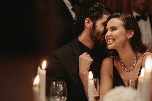 Beautiful couple having a great time at dinner party