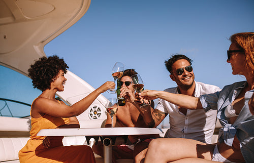 Friends partying on a boat with drinks