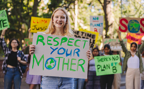 Cheerful teenager leading a march against climate change