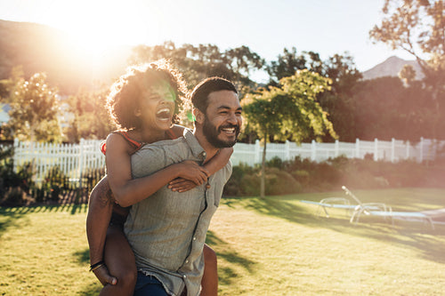 Young romantic couple playing in their garden