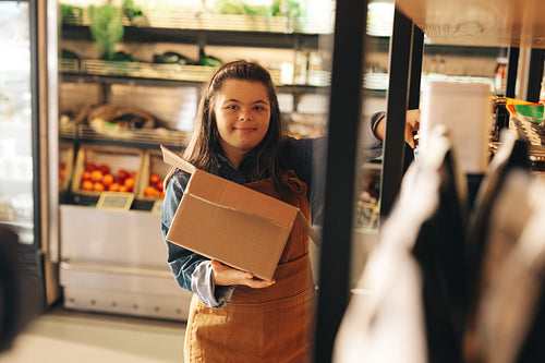 Store worker with Down syndrome restocking food products
