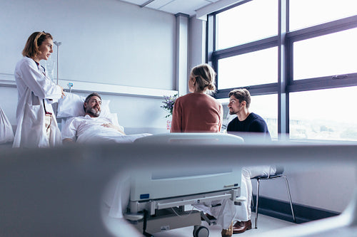 Female doctor visiting patient in hospital room