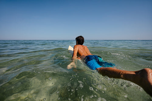 Male surfer in the sea water with surf board