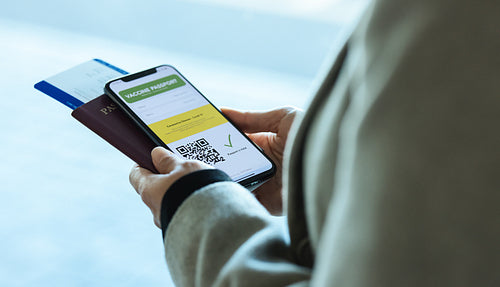 Woman traveling during pandemic using vaccination passport