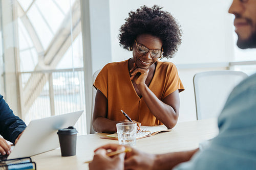 Business woman sitting in a collaborative brainstorming session in a professional office