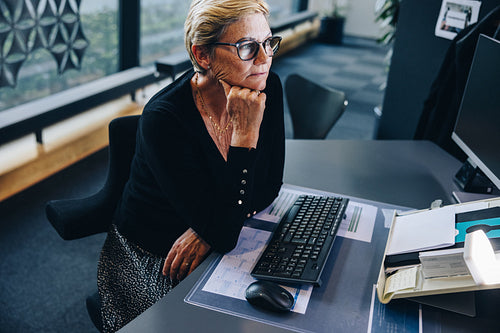 Senior businesswoman sitting at her desk