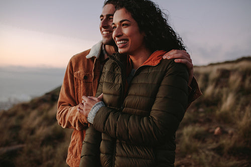 Loving couple looking at view and smiling