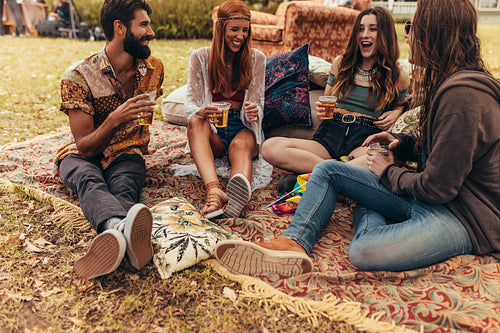 Friends hanging out with beers at summer festival