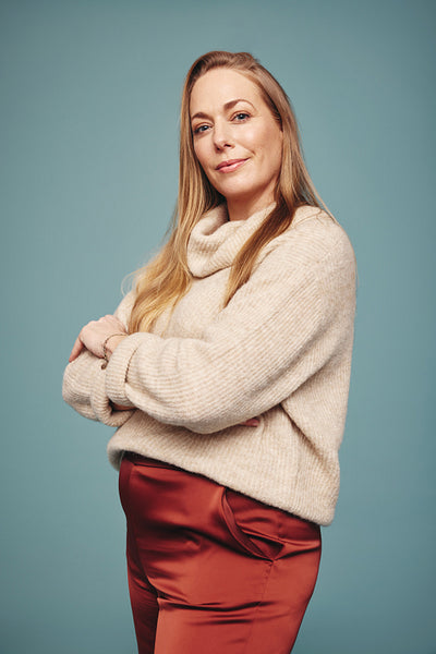 Strong independent woman standing alone in a studio
