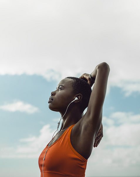 Female in sportswear doing arms stretches