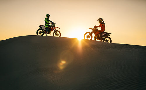 Motocross bikers on their bikes in a desert