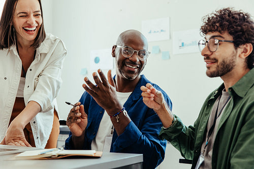 Happy employees having a discussion during a break at a meeting