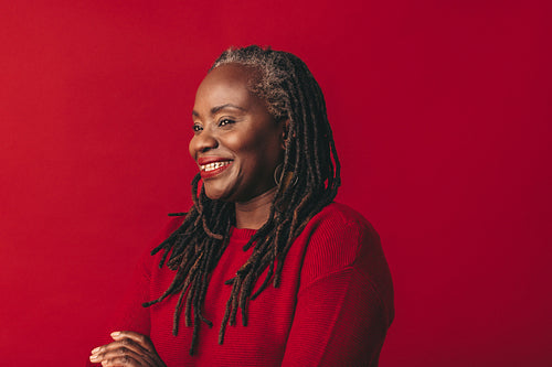 Cheerful black woman smiling in a studio