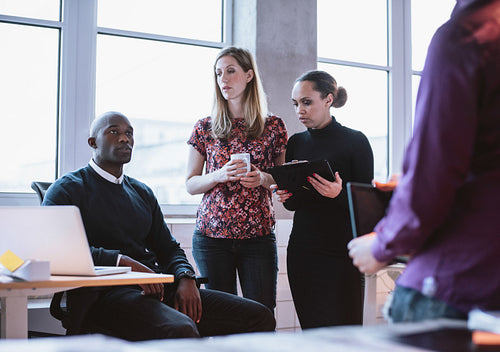Business people having informal meeting in office
