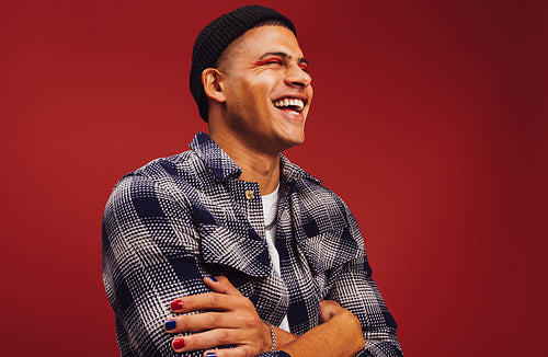 Carefree young man smiling with his eyes closed