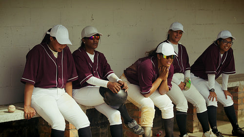 Women's baseball team rests in dugout