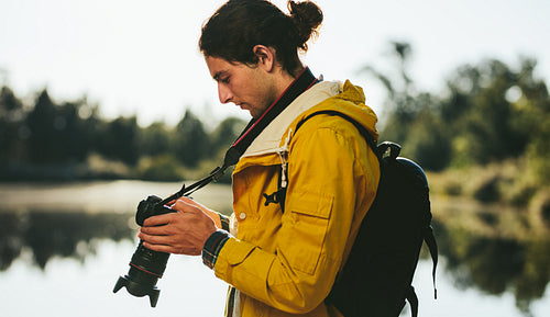 Photographer standing outdoors taking photos of nature