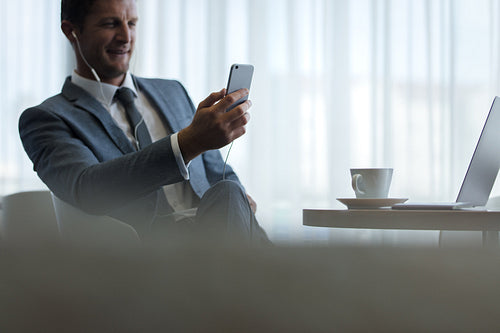 Businessman at office lobby making video call