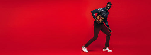 African american man running with a gift