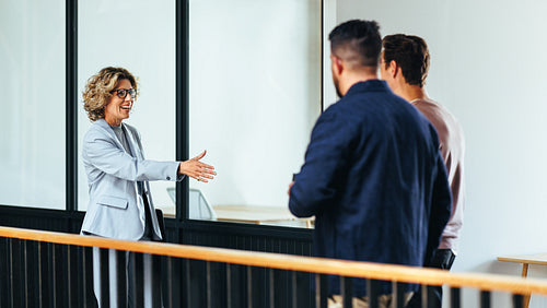Business woman reaches out for a handshake as she meets her new partners
