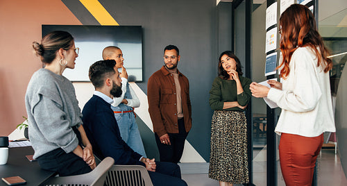 Young businesspeople discussing some reports in a boardroom