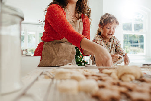 Mother and child making cookies for Christmas.