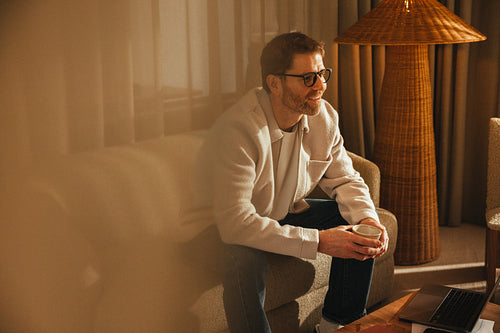 Business owner pauses pensively in his office space