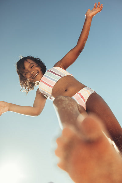 Young girl playing and having fun at the beach