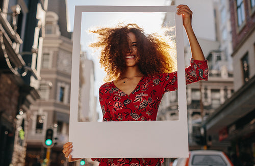 Female traveler with empty picture frame