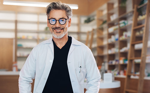 Portrait of a male pharmacist standing in a drug store