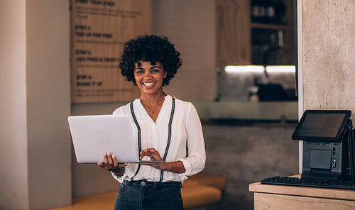 Female cafe owner with laptop