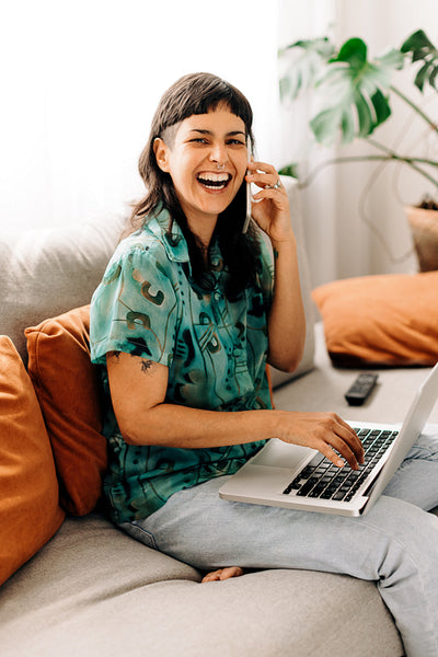 Woman closing business deals from her couch