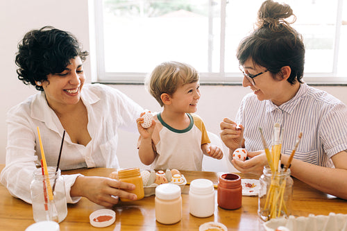Happy family painting Easter eggs