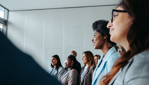 Engaged group of business professionals attending a conference in modern office setting