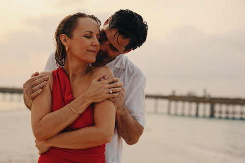 Romantic moment for older couple on honeymoon at the beach