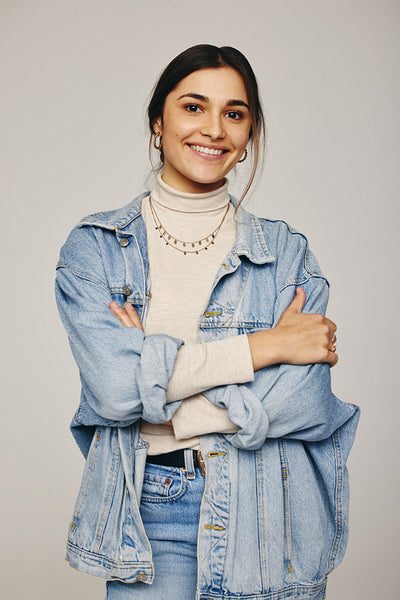 Stylish young woman smiling at the camera in a studio