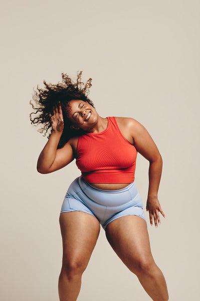 Curvy woman doing fun body movements in a dance workout session