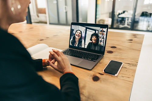 Happy businesswoman attending a video conference in an office