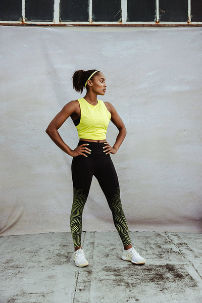 Fitness woman standing on building terrace