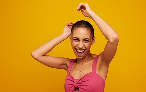 Fashionable female model on yellow background
